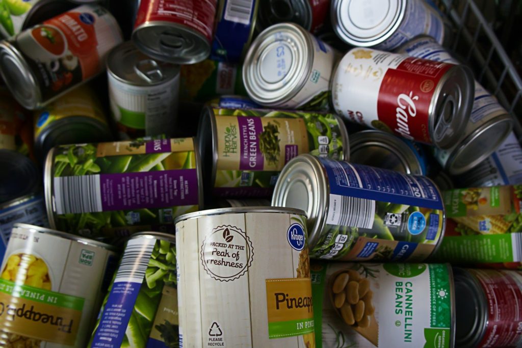 A pile of cans of food sitting next to each other