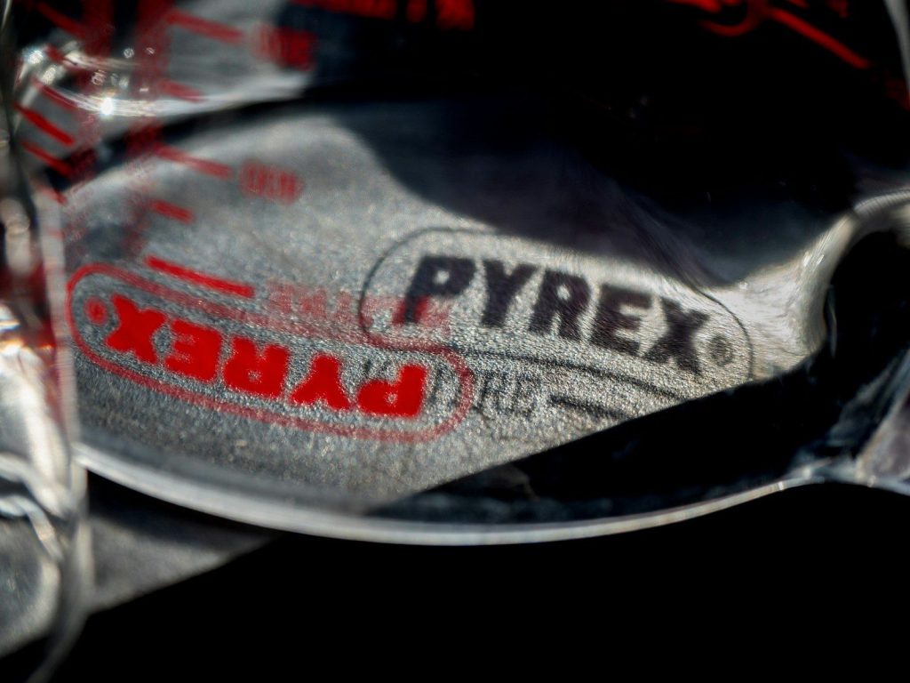 Close-up of pyrex logo on crumpled metal
