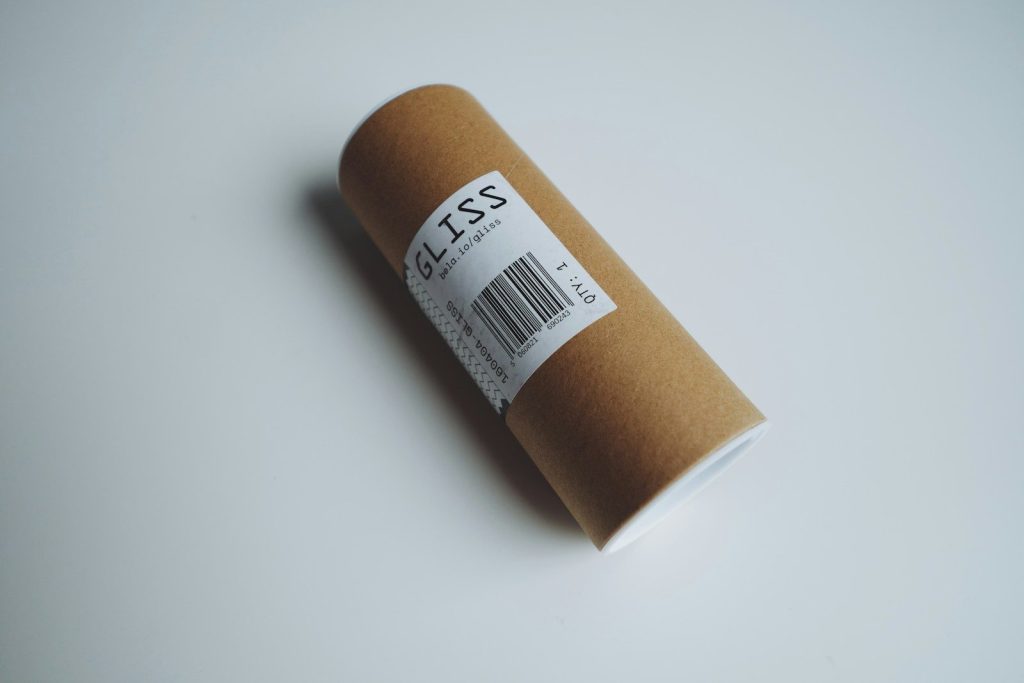 Brown cardboard tube with a label