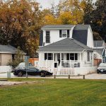 a couple of cars parked in front of a house