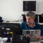 man sitting beside desk