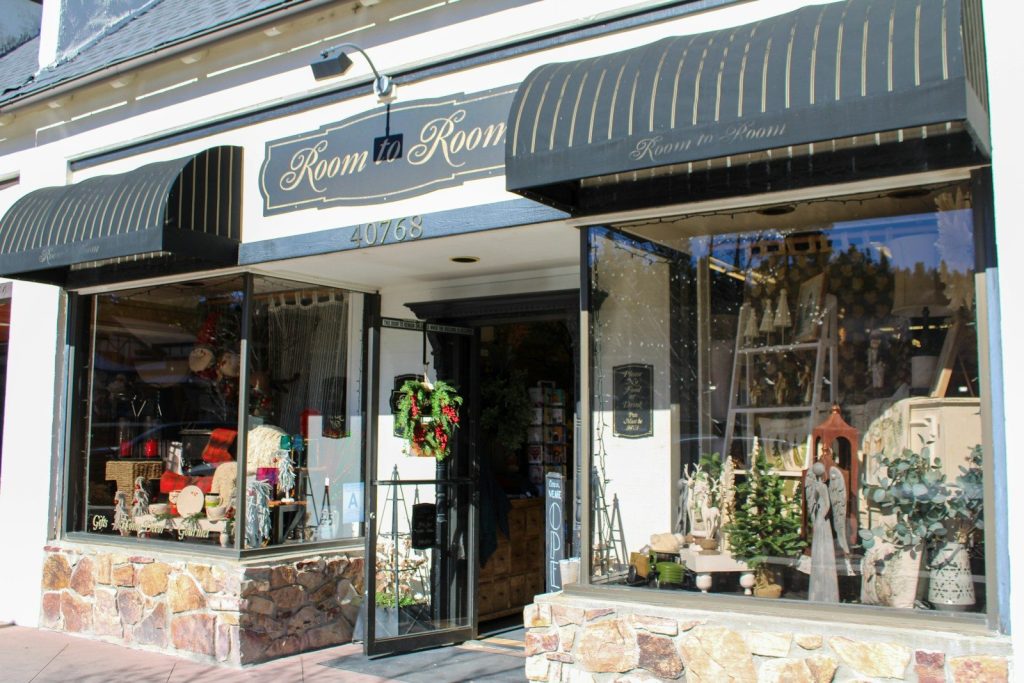 A quaint storefront with awnings and displays.