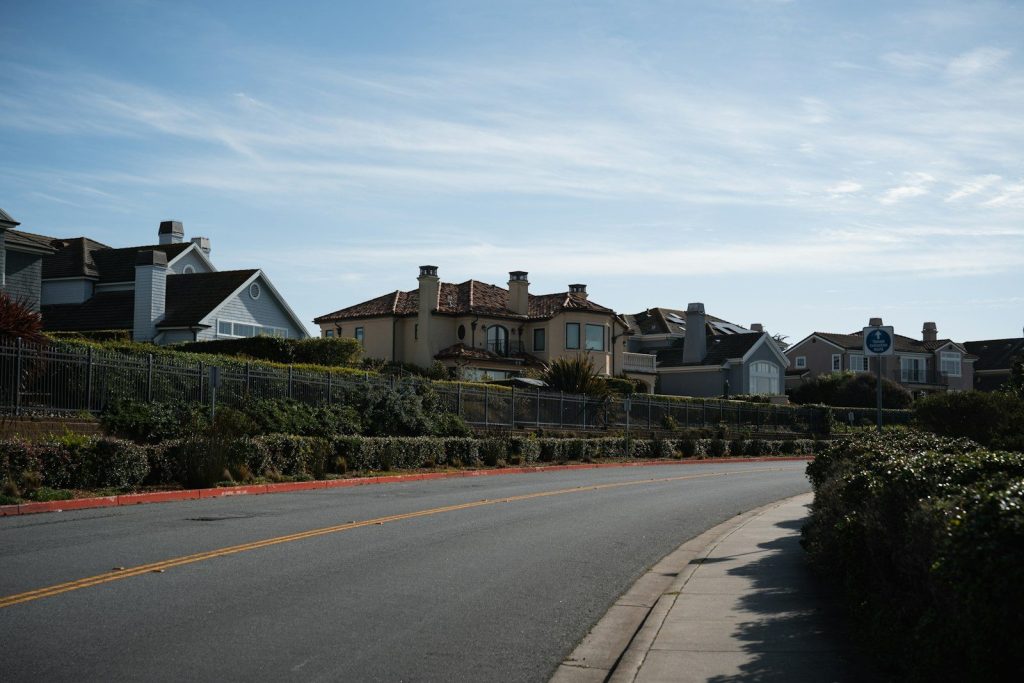 Suburban street with houses on a hill.