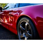 a red sports car parked on the side of the road