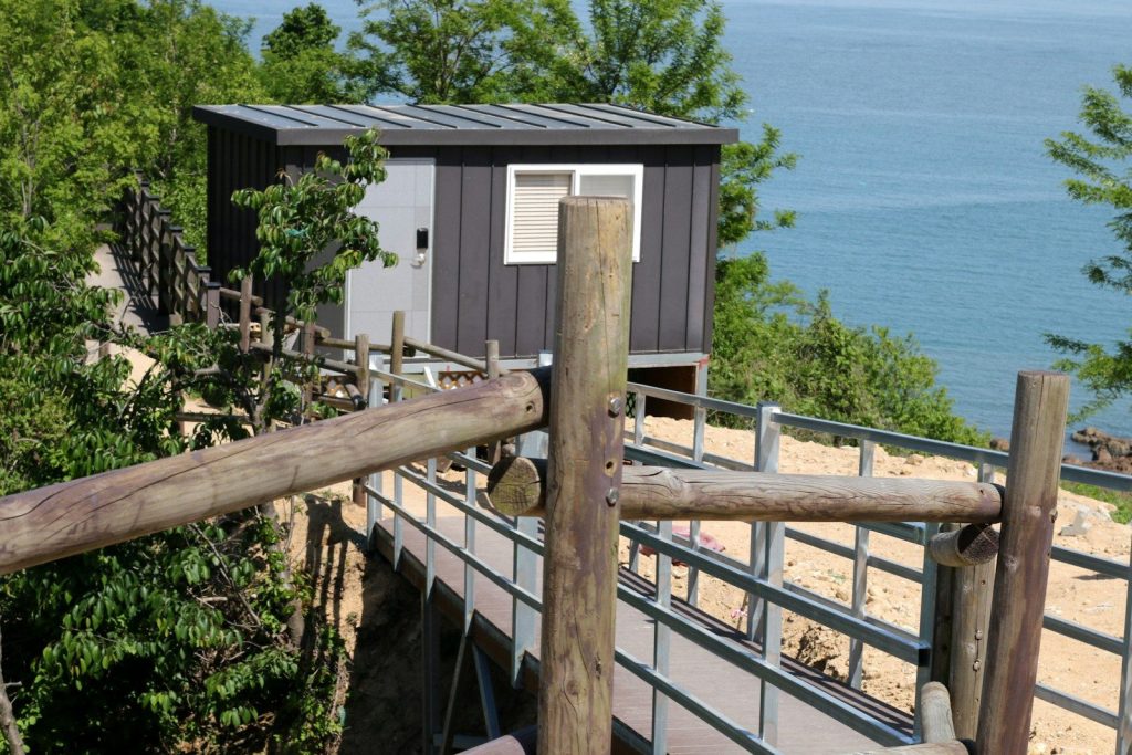 Modern cabin overlooking a calm blue ocean
