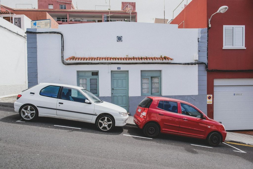 white and red 5-door hatchbacks on street