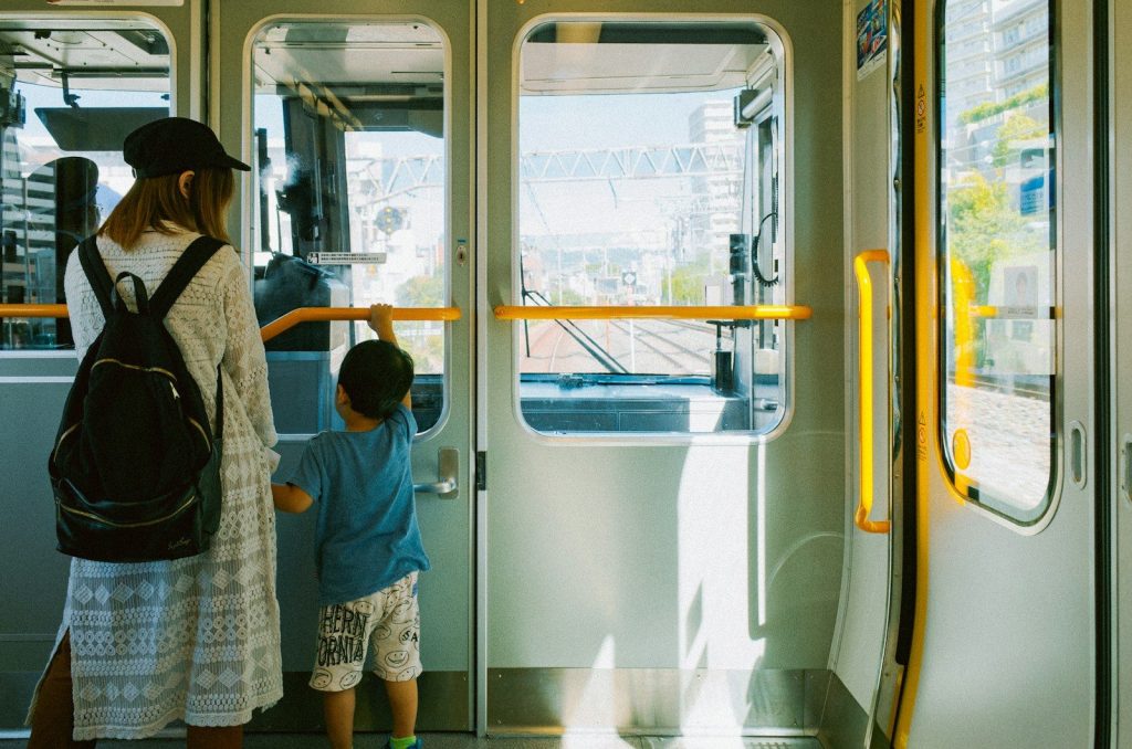 Mother and child looking out train window