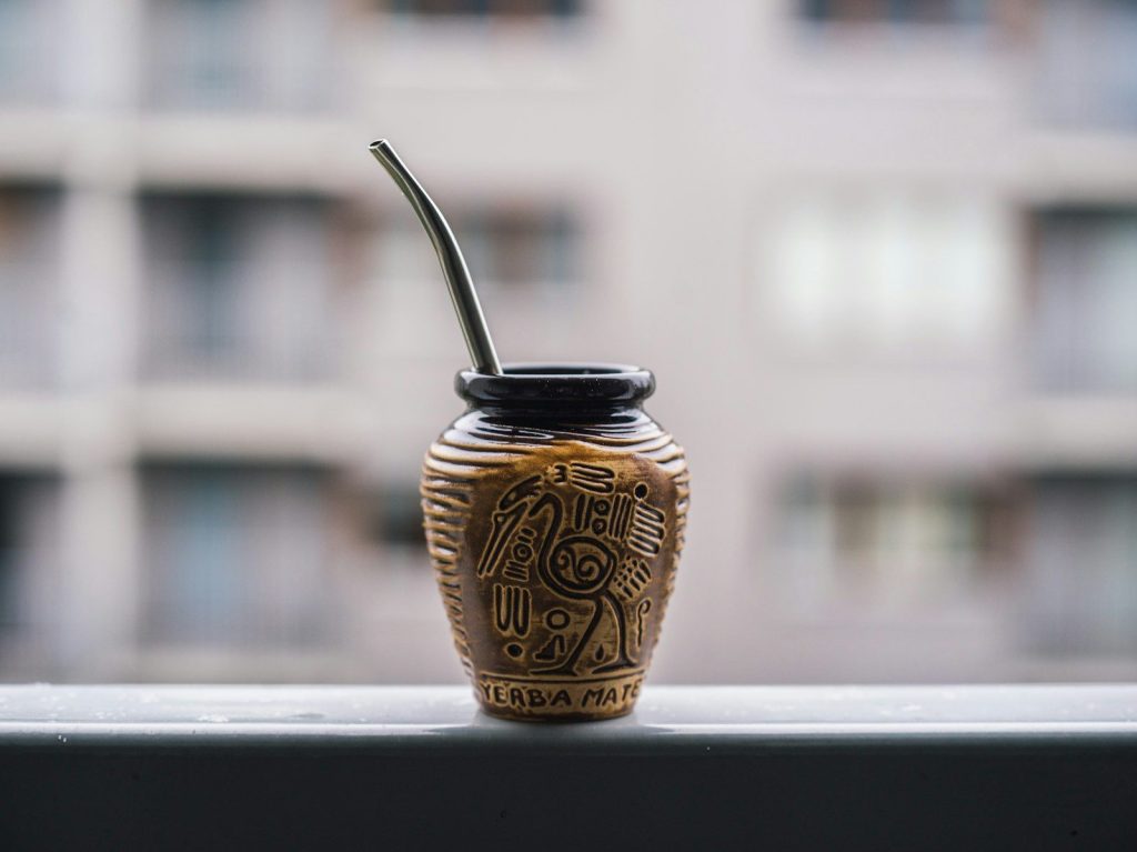 a vase with a straw sticking out of it