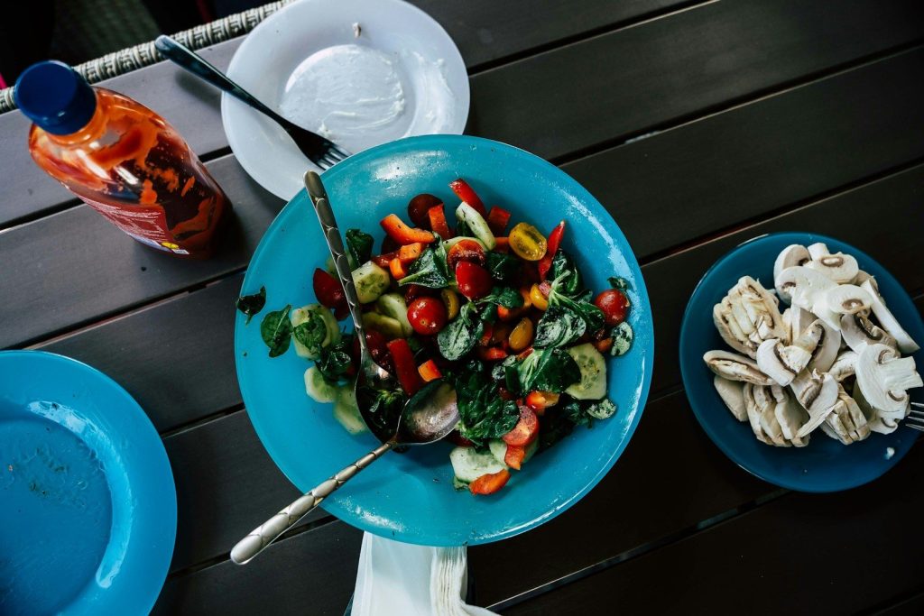 sliced vegetables on blue ceramic bowl