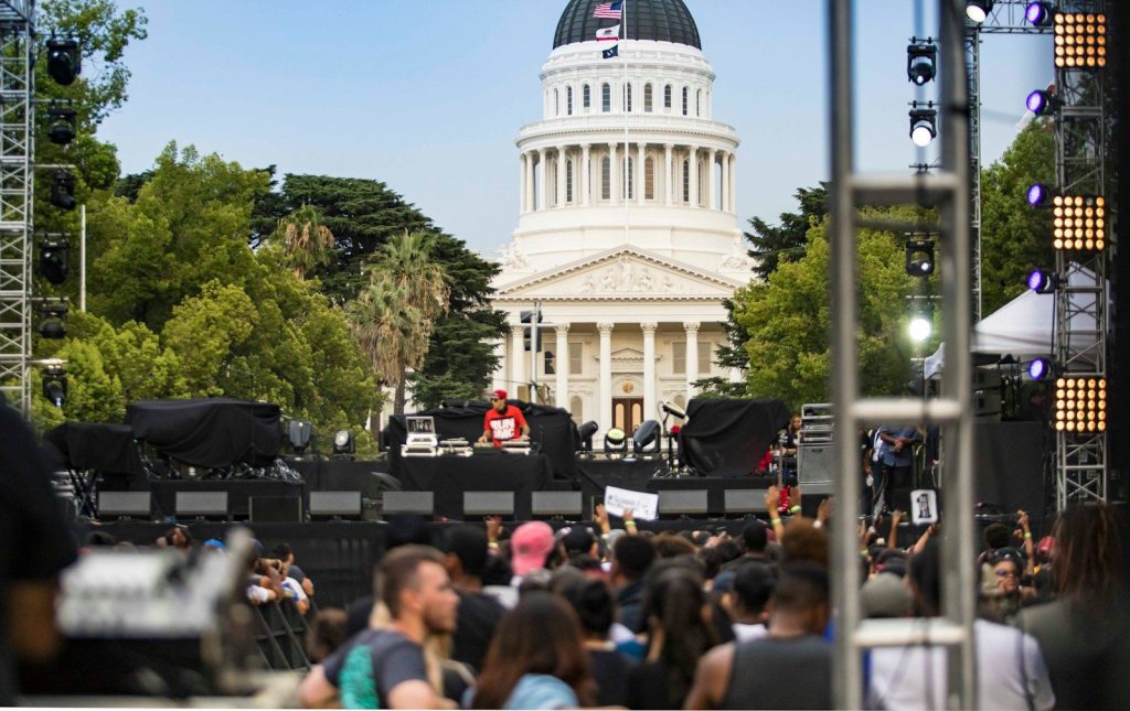 a large crowd of people in front of a white building