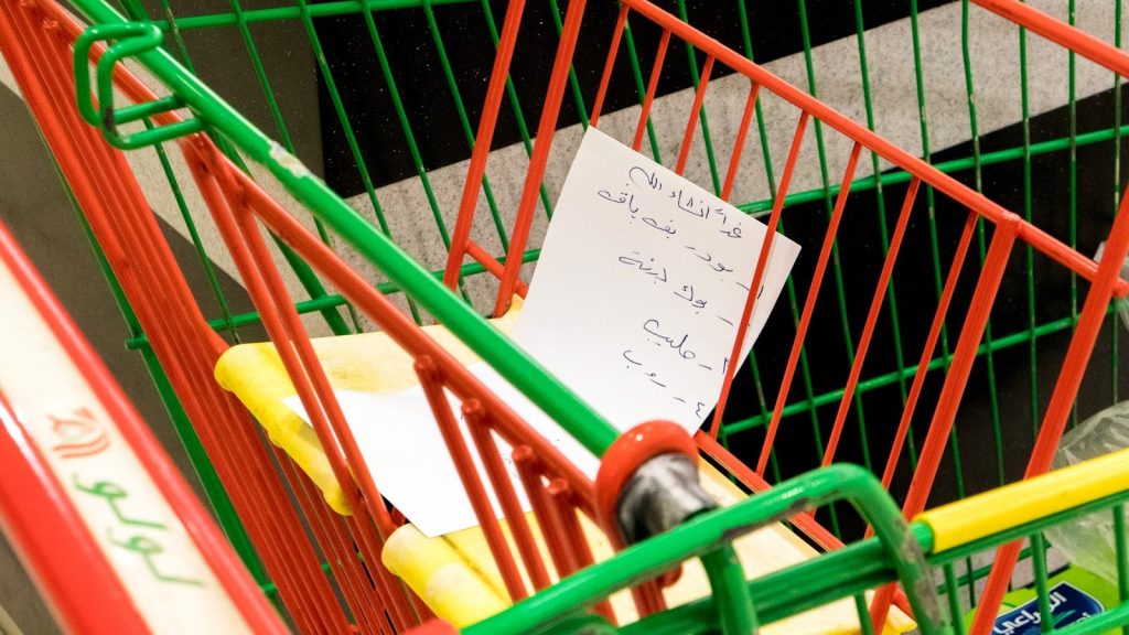 a shopping cart with a note attached to it