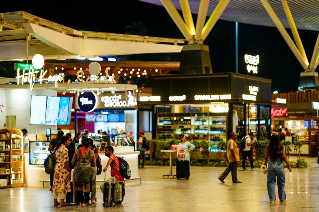 People walking through a modern airport terminal at night