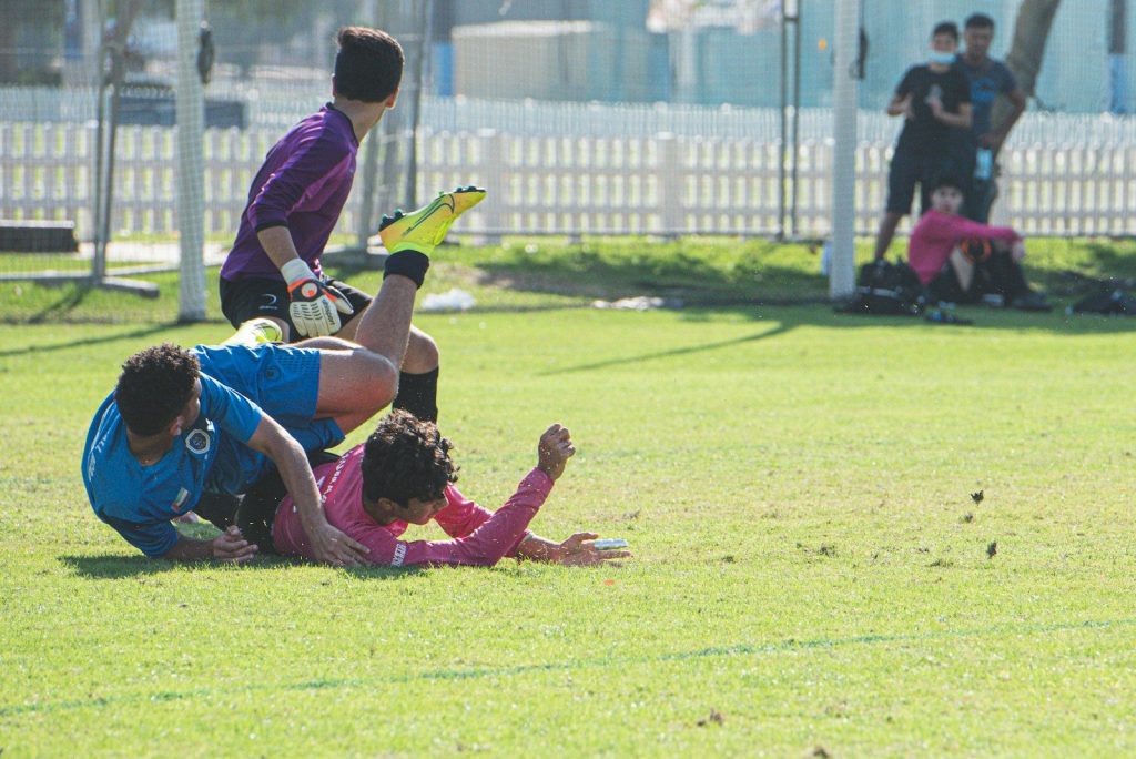 group of people lying on green grass field during daytime