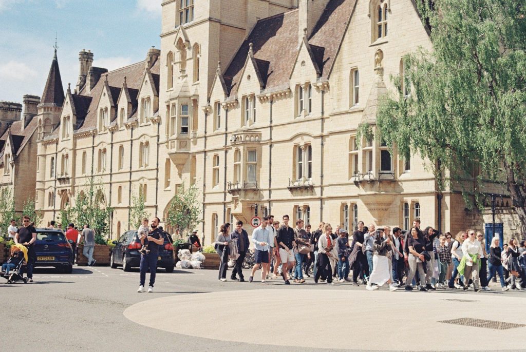 a large group of people walking in front of a building