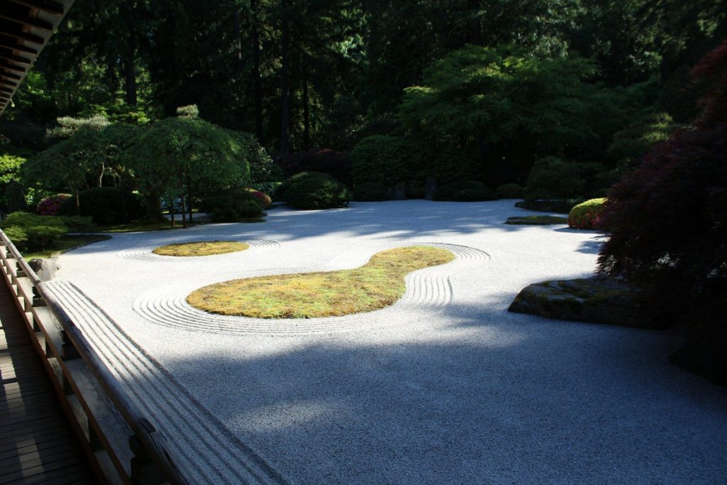 a view of a japanese garden from a bridge