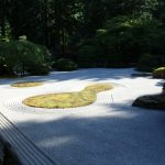 a view of a japanese garden from a bridge