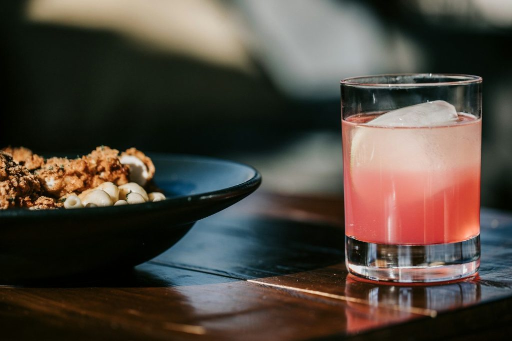 a table with a plate of food and a drink