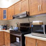 white microwave oven on brown wooden kitchen cabinet