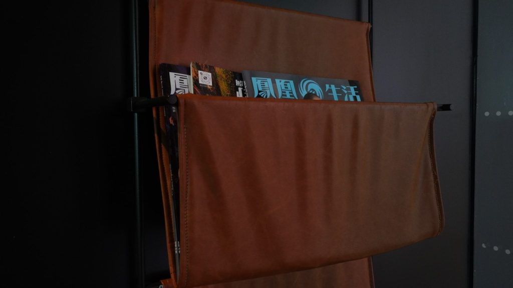 There is a book shelf in the corner of the room