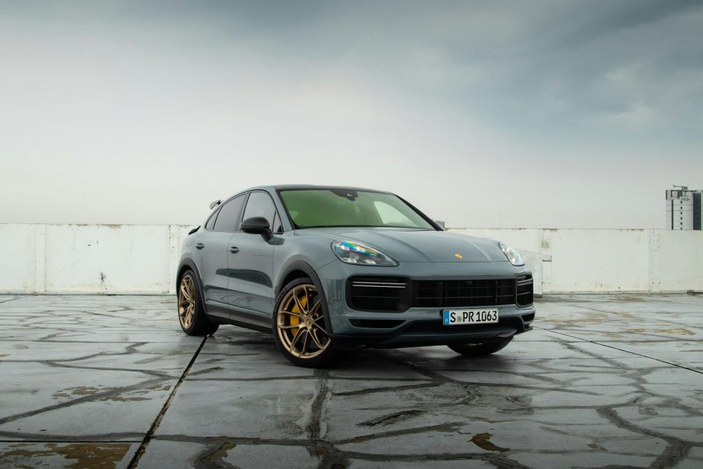 a grey porsche cayen is parked in a parking lot