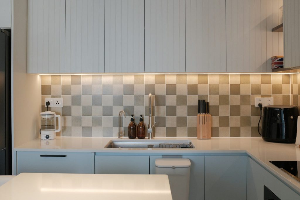 A kitchen with a refrigerator and a sink