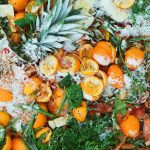 sliced orange fruits on green leaves