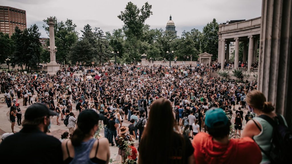 a large crowd of people in a city square