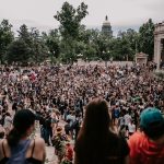 a large crowd of people in a city square