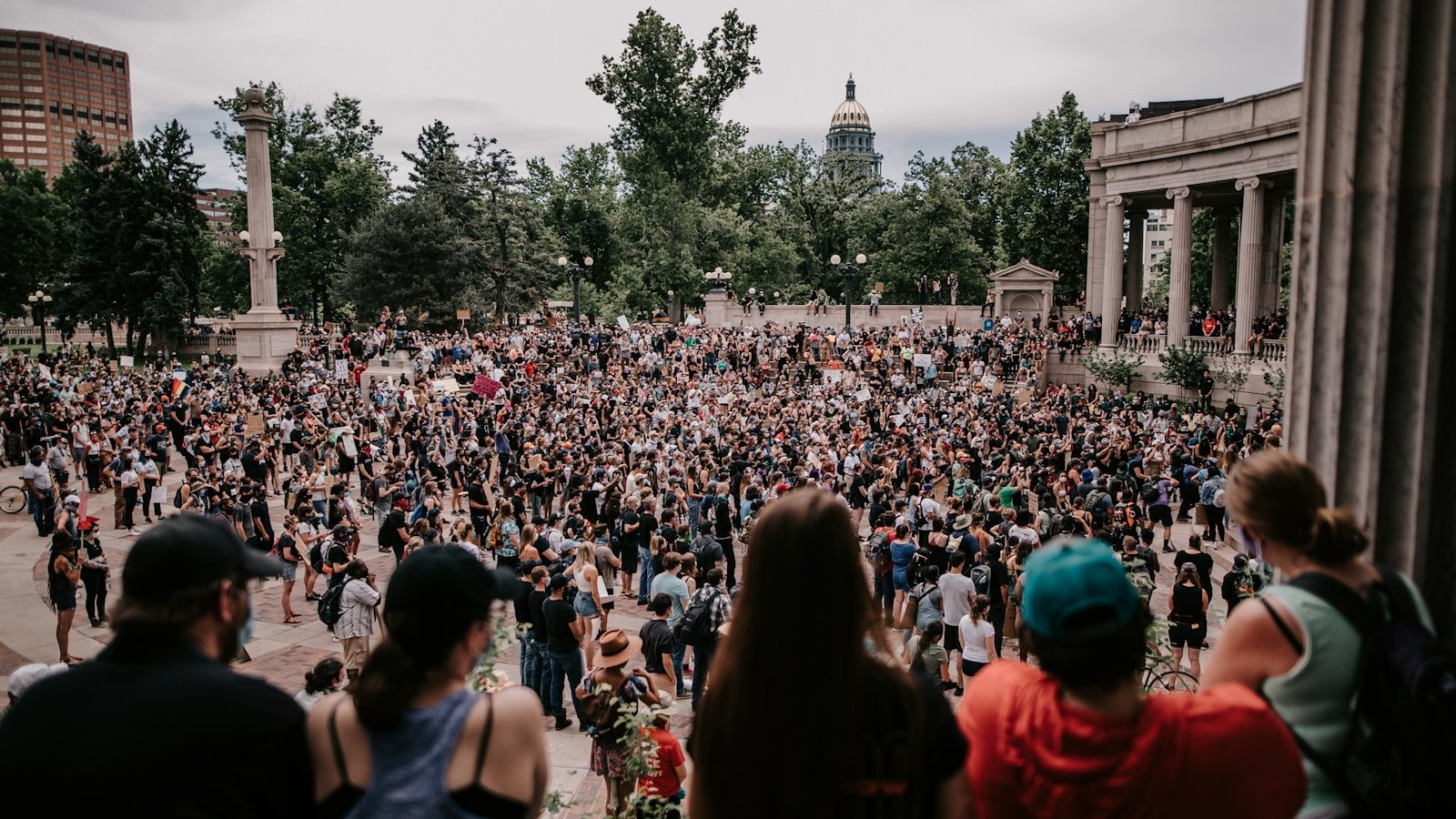 a large crowd of people in a city square