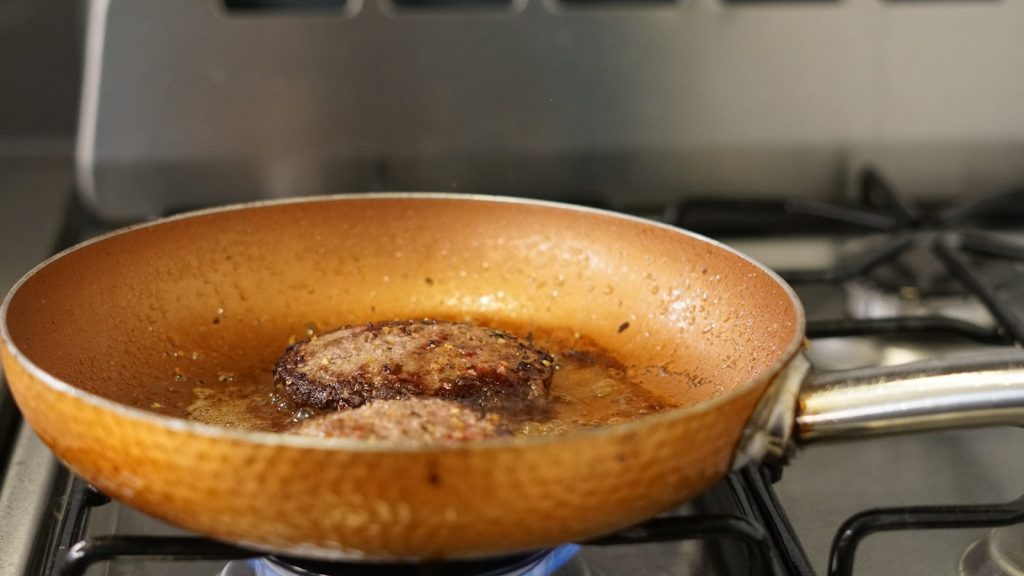 a frying pan filled with food on top of a stove