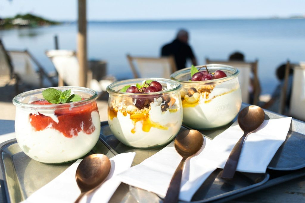 A table topped with desserts on top of a metal tray
