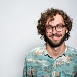 smiling man with glasses and beard portrait
