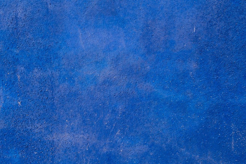 a close up of a tennis racket on a blue surface