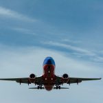 blue and red airplane on sky