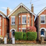 a row of brick houses with white windows