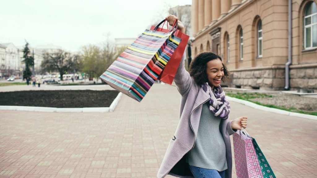 Woman holding shopping bags with a smile
