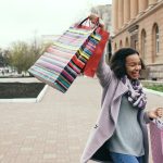 Woman holding shopping bags with a smile