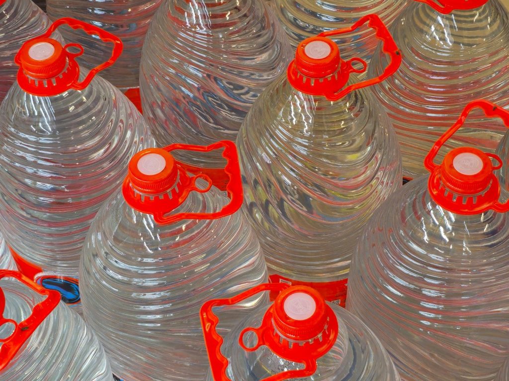 Water jugs with orange lids are shown.
