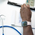 a hand holding a smart watch