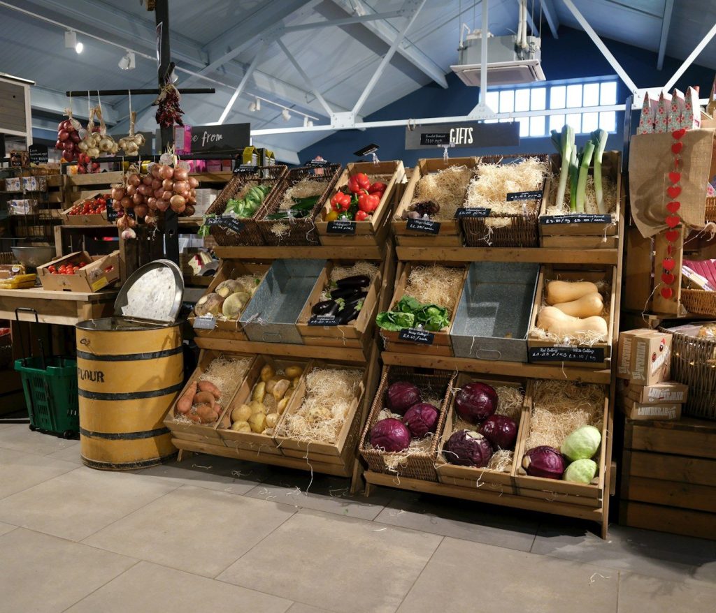 Fresh produce displayed in wooden crates at a market.