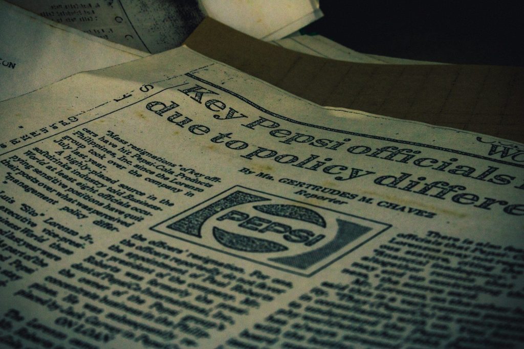 a pile of newspapers sitting on top of a table