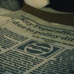 a pile of newspapers sitting on top of a table