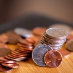 silver and gold coins on brown wooden table