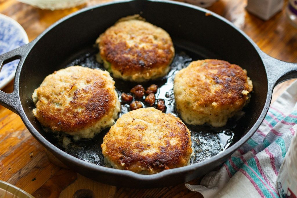 A pan filled with food on top of a wooden table