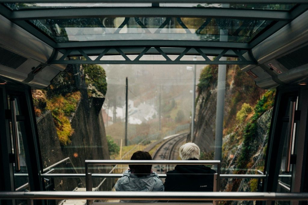 two person sitting inside cable car