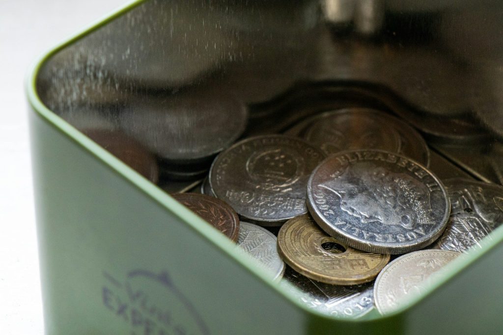 silver round coins on brown wooden container