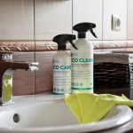 a bathroom sink with two cleaning products on it