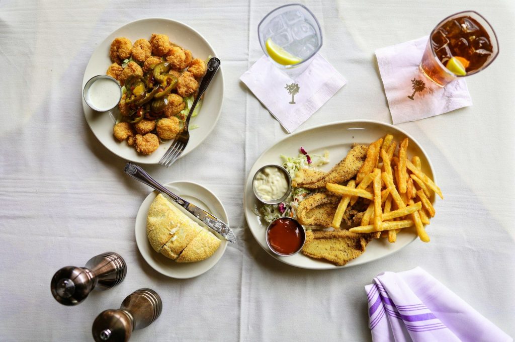potato fries and fried chicken on white ceramic plate