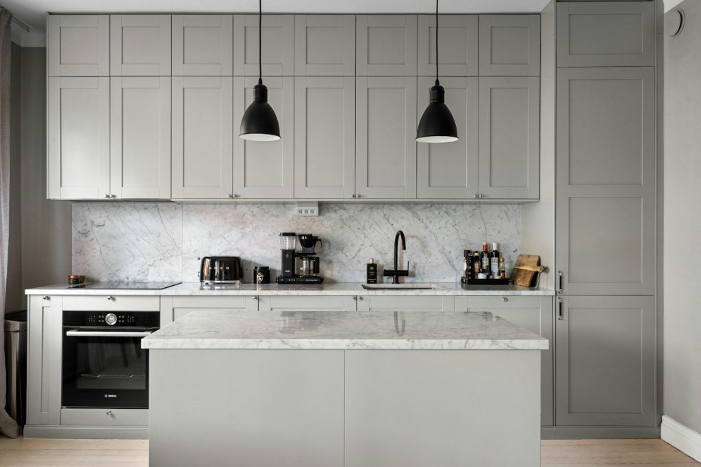 A kitchen with a stove, sink, and oven