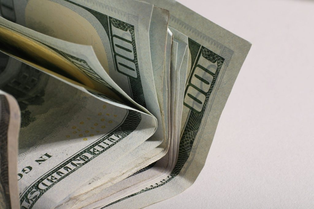 A close-up of a stack of us hundred dollar bills.